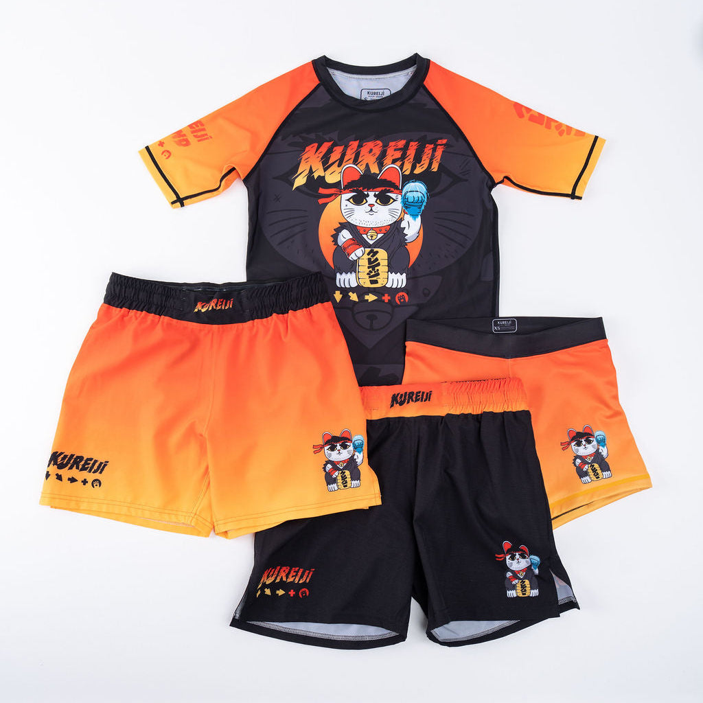 Kureiji Neko Fury Sunrise Combat Shorts flat lay collection showing three shorts styles alongside matching short-sleeve rash