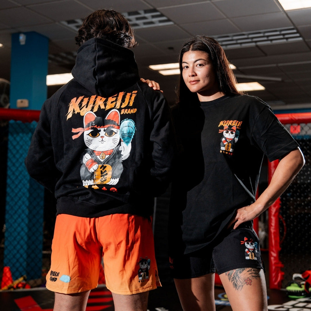 Kureiji Heavyweight Tee - Neko Fury, front chest graphic shown worn in a gym alongside a matching hoodie and shorts set